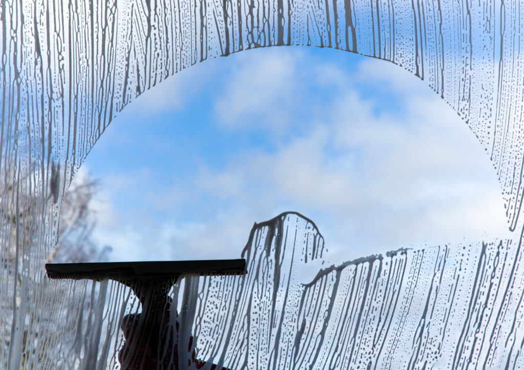 squeegee is being used in cleaning window